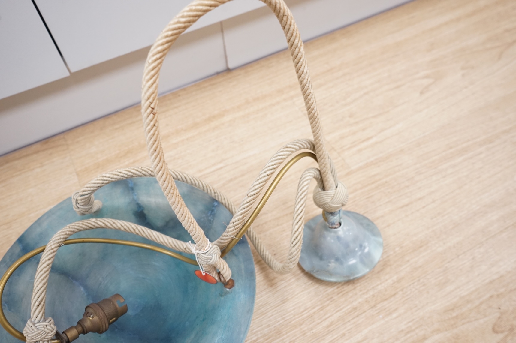 A French Art Deco blue alabaster plafonnier and matching ceiling rose, with cream cord, inscribed number, 30cm diameter